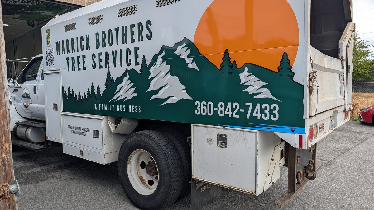 The Warrick Brothers chip truck with the crest, the treeline and the phone number on its side