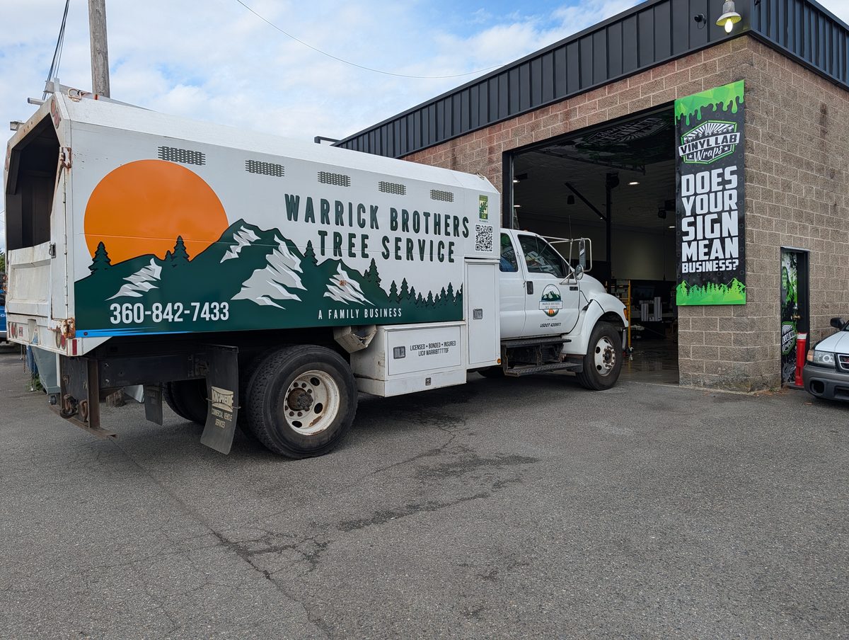 The back of the Warrick Brothers chip truck parked on a gravel yard